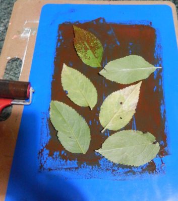 The leaves are laid out on top of the paint.
