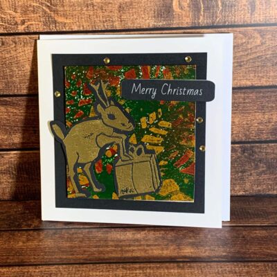 Frisky Gold Reindeer with Present on Festive Print